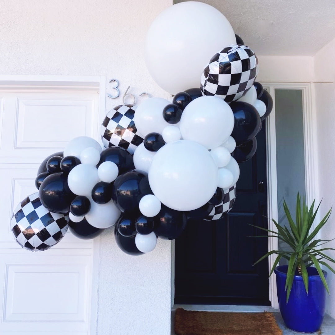 Black and white balloon garland with race car party decorations Race car party balloon decoration ideas - Los Angeles balloon installation