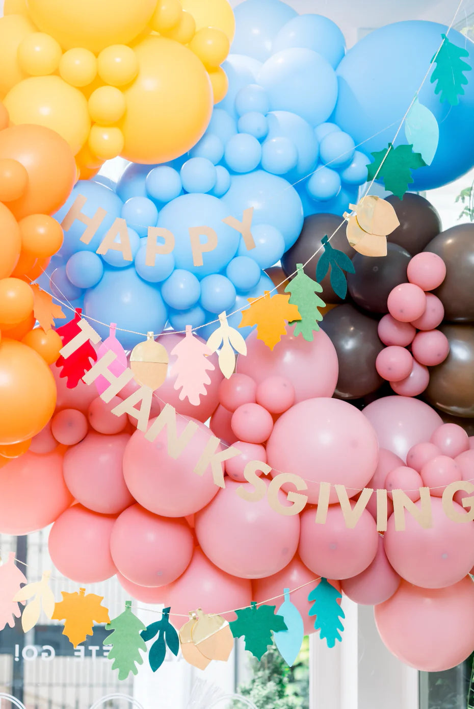 thanksgiving-themed banners and balloons for a kid thanksgiving party