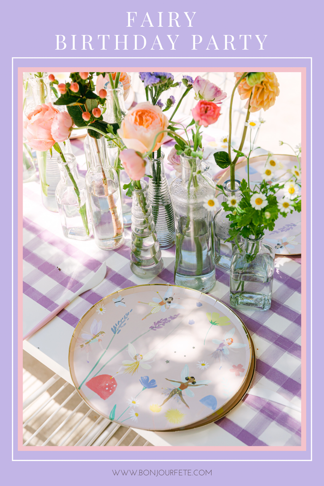 Fairy birthday party table with lavender gingham linens, fairy print plates, and glass bud vases of fresh flowers.