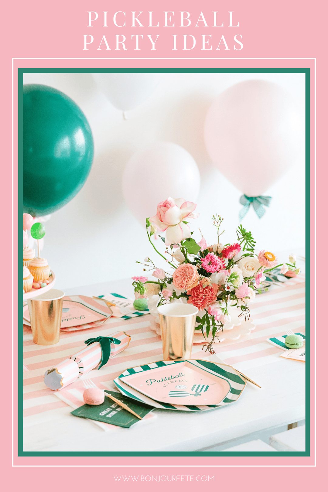 Pickleball party table with pink striped linens, pickleball plates, gold cups, pink and green balloons, and florals.