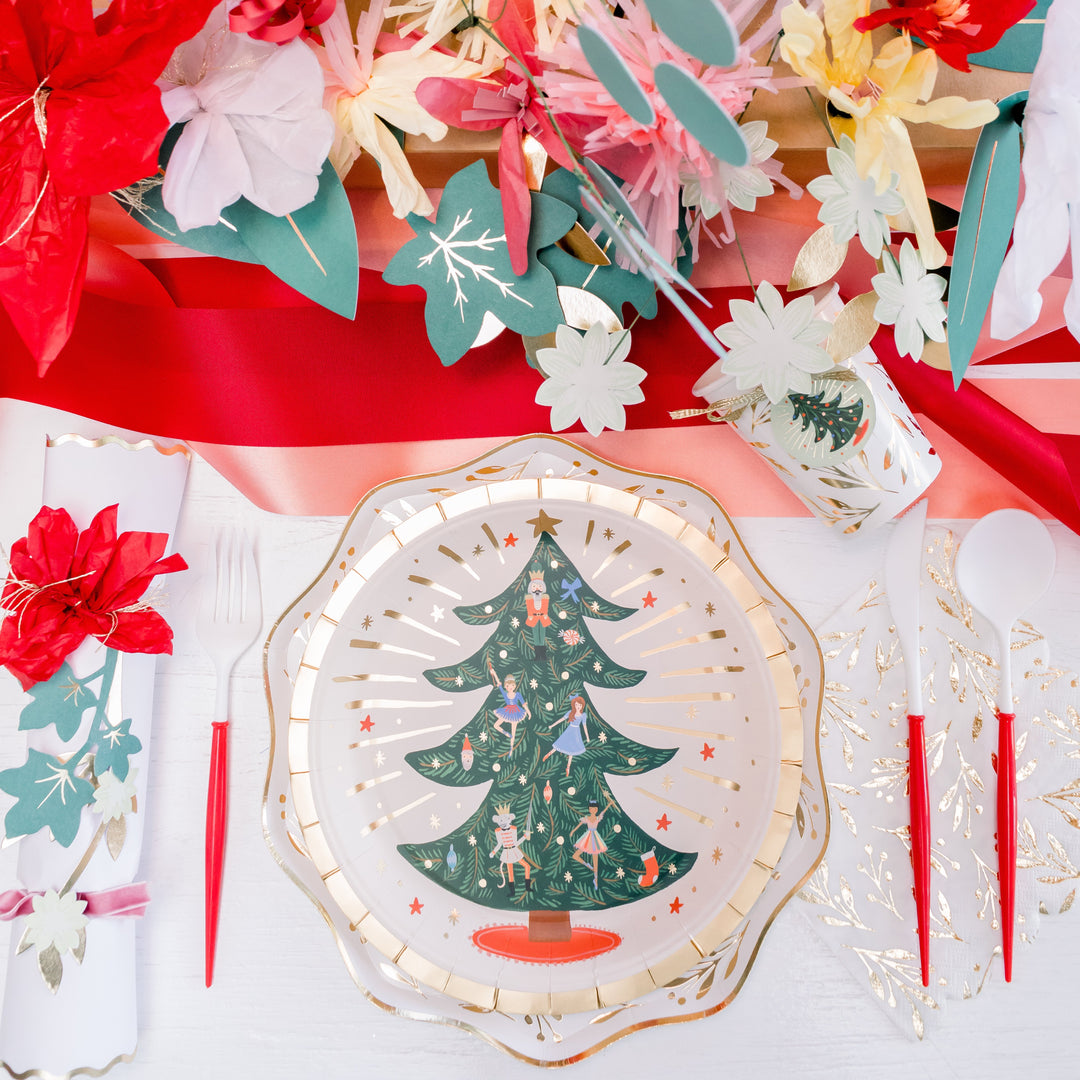 Nutcracker Christmas party table with ballet-themed plates, napkins, and wooden nutcrackers for a holiday celebration.