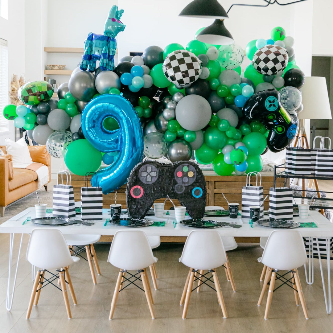 Video game party supplies and decorations styled for a gamer birthday party theme.