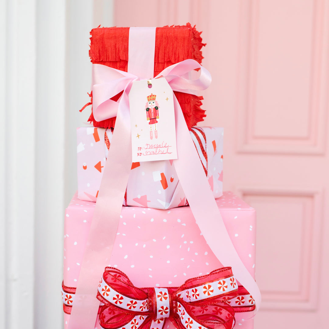 Pink christmas gifts wrapped and stacked on top of each other. Premium Christmas and holiday gift wrapping supplies