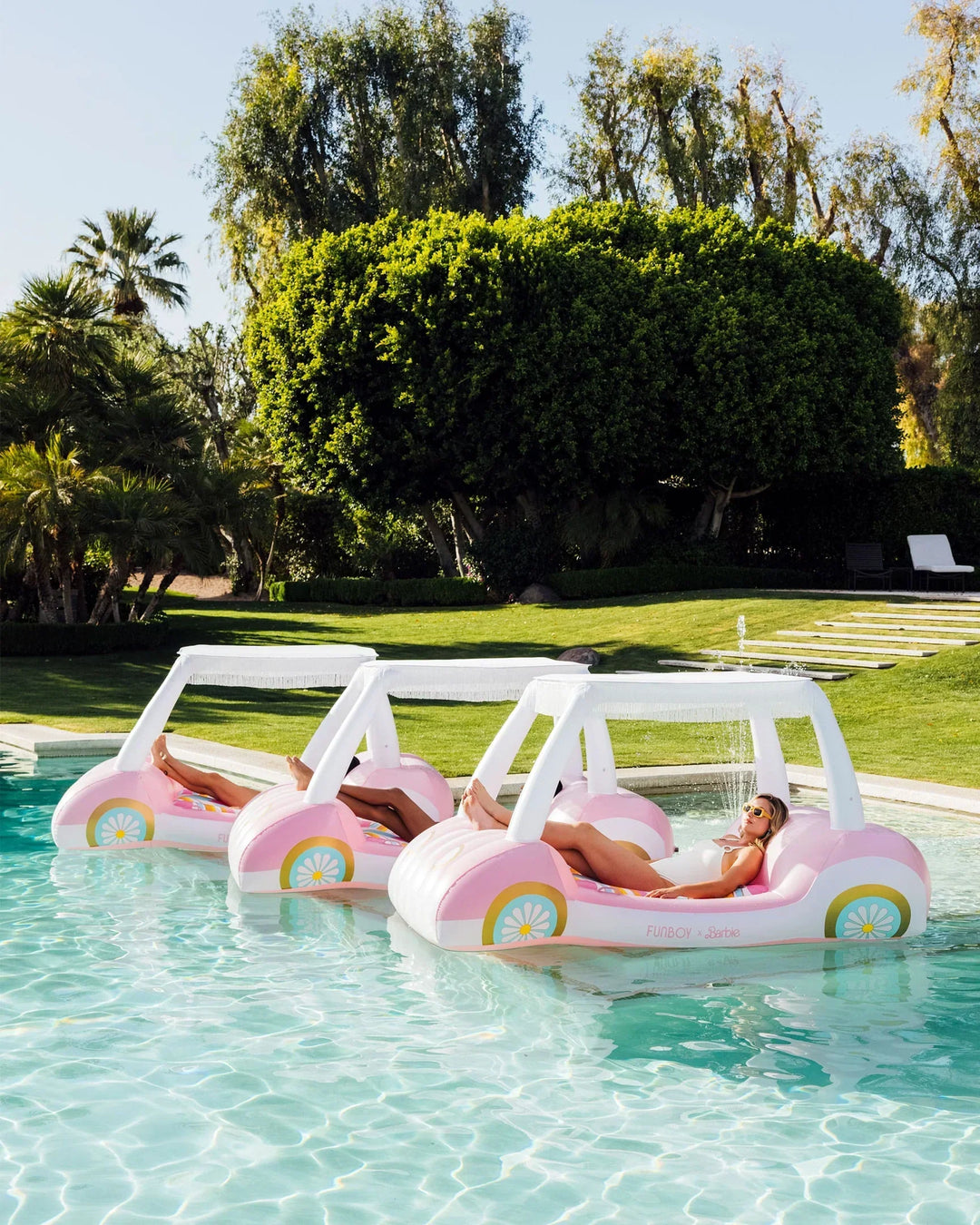 FUNBOY luxury pool floats in bright designer shapes styled poolside for summer pool parties and backyard celebrations.