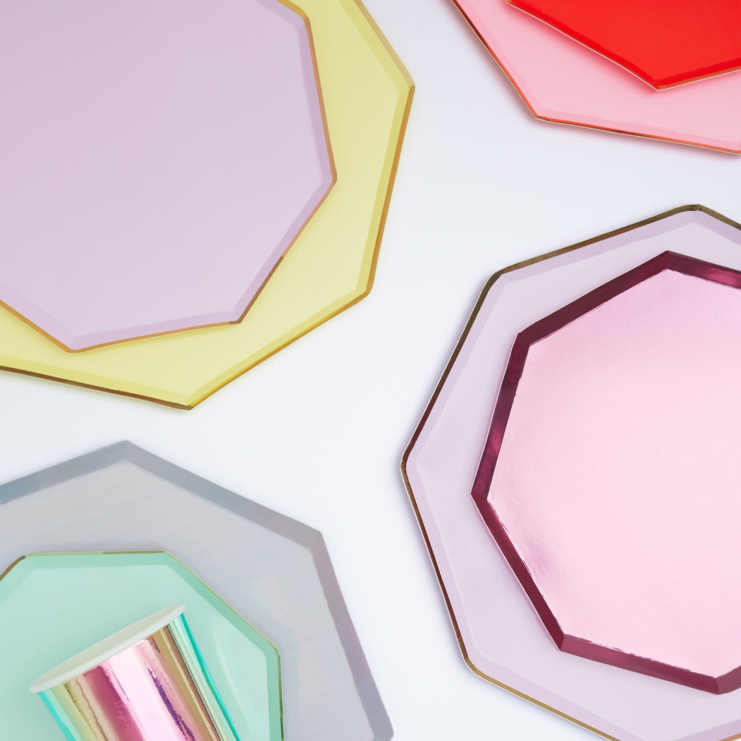 Paper party plates in lilac, yellow, coral, pink, and mint with gold-rimmed octagonal edges for birthdays and showers.