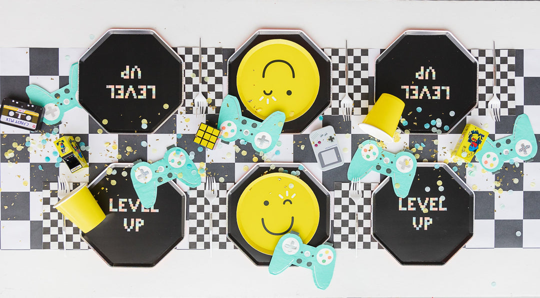 Video game themed party table setting with coordinating party supplies for a gamer birthday