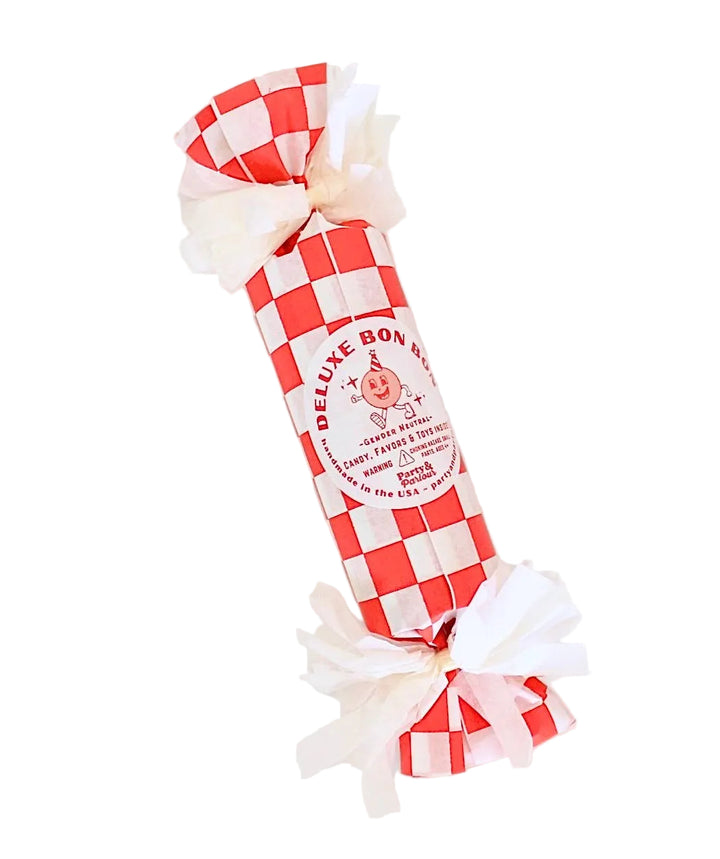 Red and white checkered deluxe surprise bon bon with white pom poms for a kids' birthday place setting
