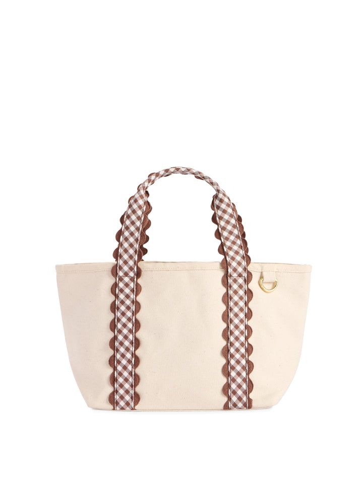 A cream canvas tote bag with brown and white gingham patterned handles and trim, featuring scalloped edges and a small gold metal D-ring, shown on a plain white background.