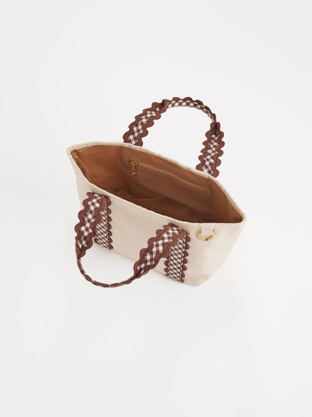 Beige tote bag with brown lace handles on a white background