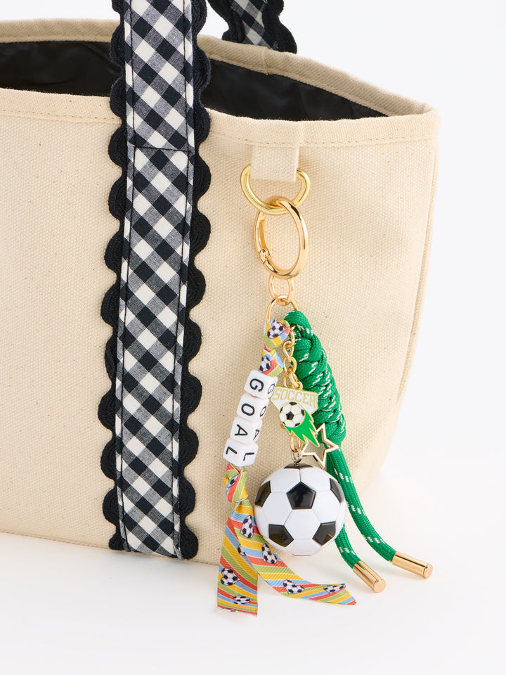 Goal soccer charm clipped to a canvas tote with gingham trim
