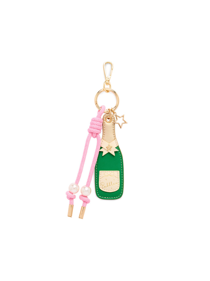 A green and pink faux leather keychain charm shaped like a champagne bottle, featuring gold-tone metal hardware, a pink braided cord with pearl beads, and a small gold star charm, shown on a plain white background.