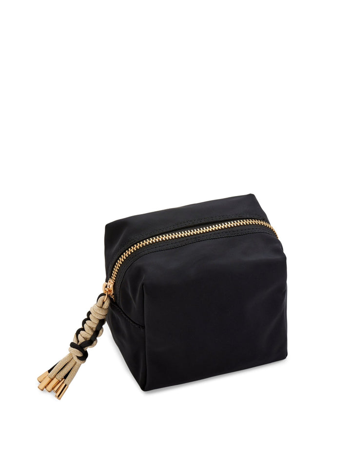 A black nylon cosmetic pouch with a gold-tone zipper and a decorative beige and black braided tassel pull, shown on a plain white background.