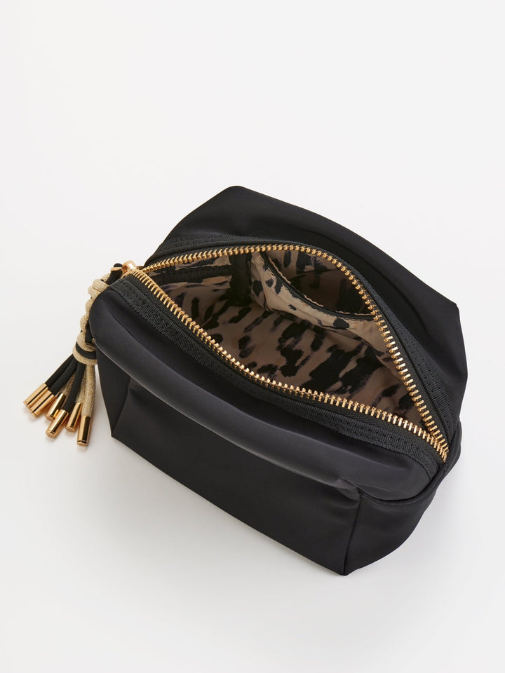 Black backpack with gold zippers and a smaller black pouch on a white background