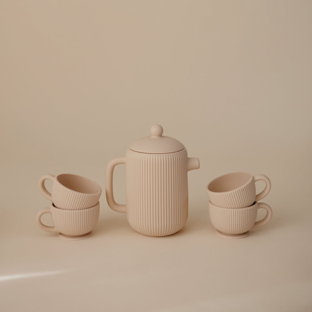 Flat lay of the Mushie silicone tea set pieces