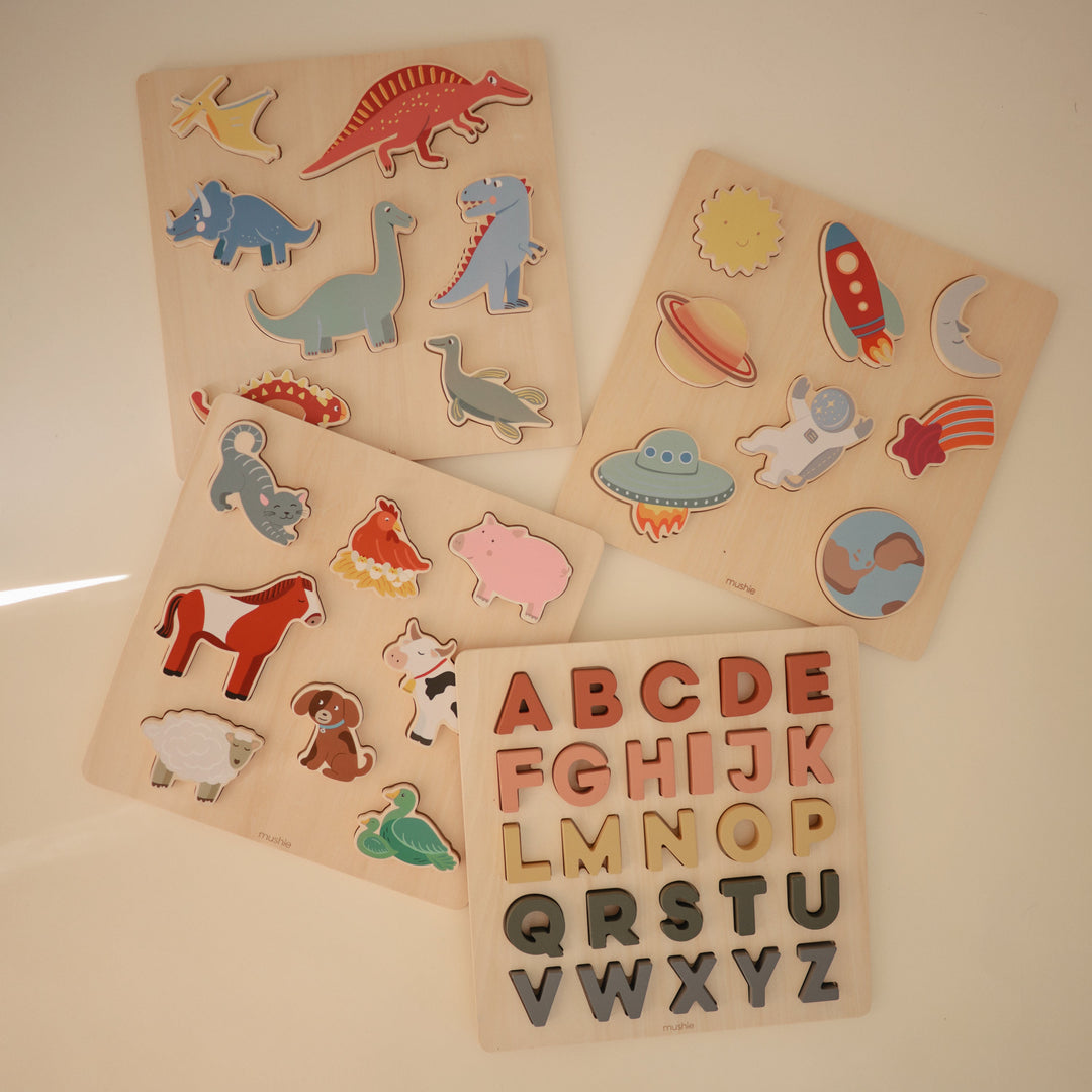 Flat lay of Mushie wooden puzzles in several designs