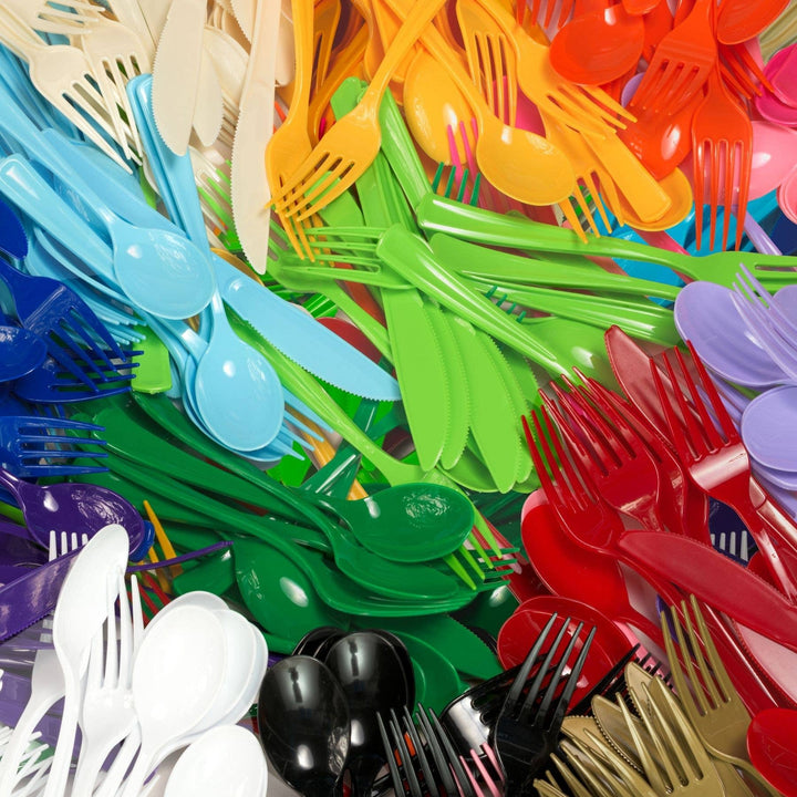 Assorted colorful plastic forks and spoons in a pile