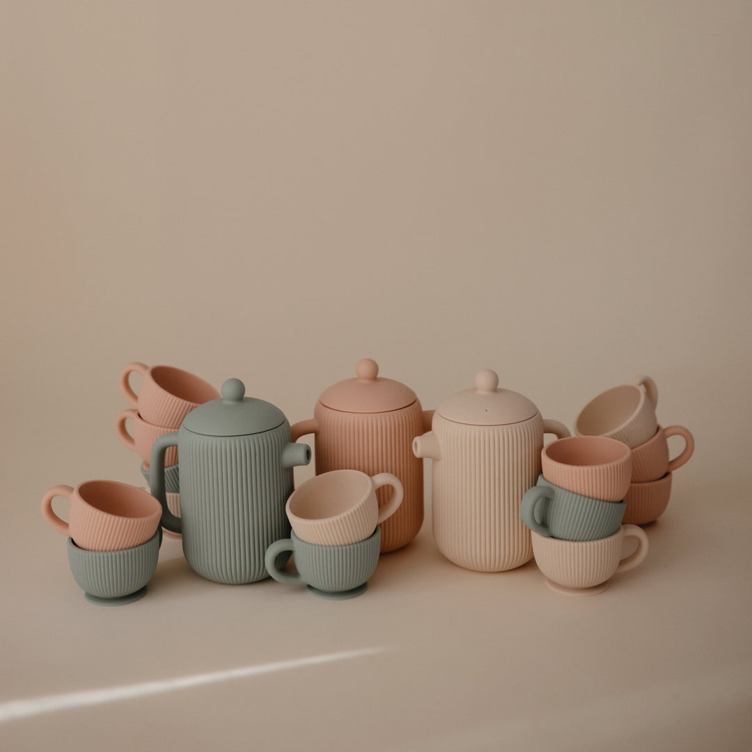 Flat lay of the Mushie silicone tea set with its teapot and cups