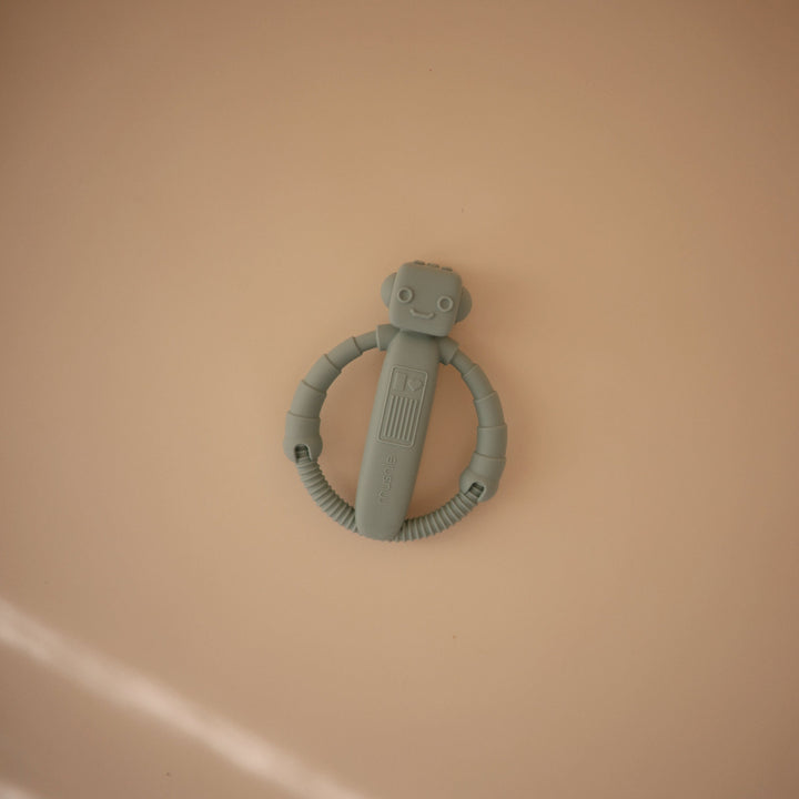 Flat lay styling of the Mushie silicone rattle teethers
