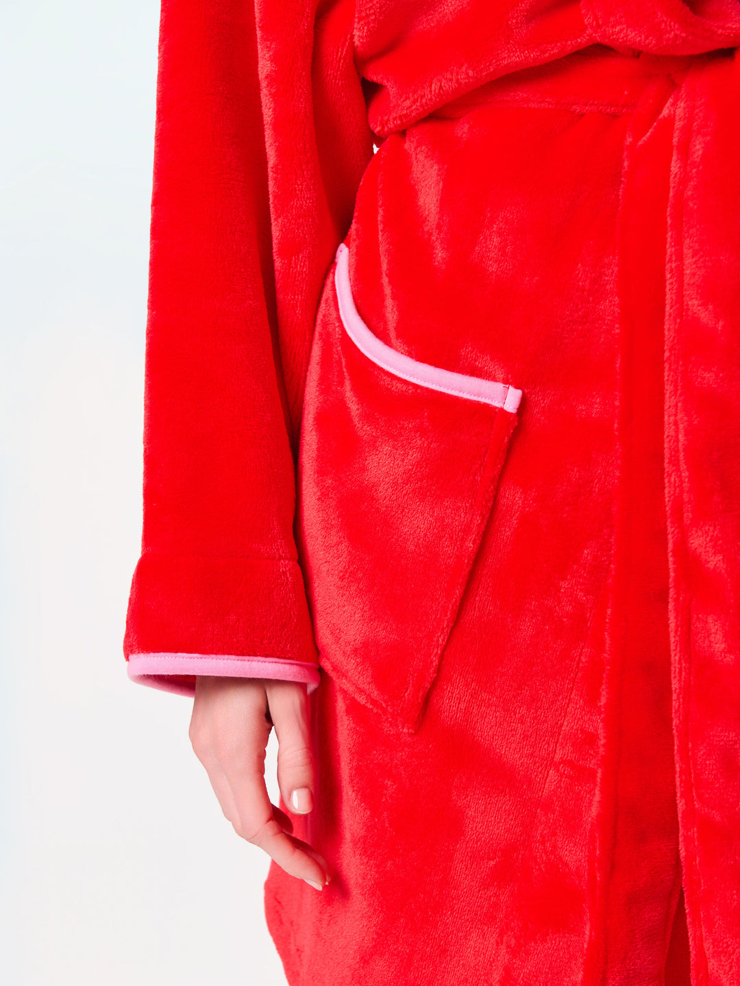 Close-up of the pink trimmed front pocket on the red robe