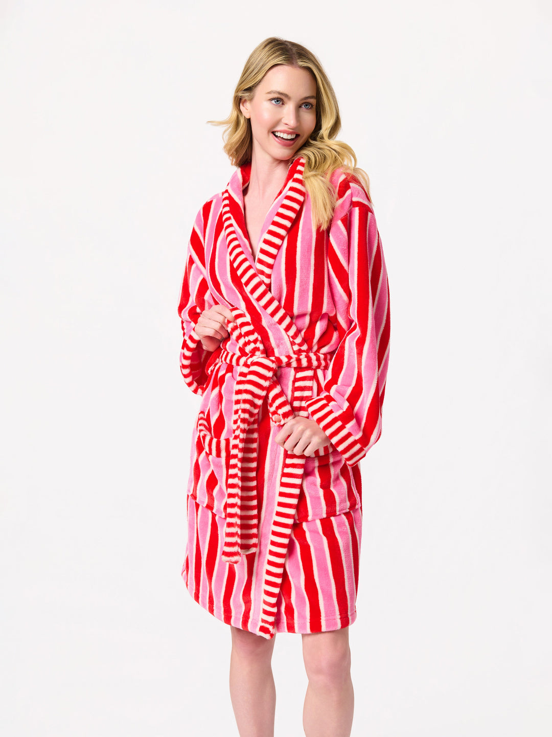 Woman in a pink and red stripe robe and red faux fur slippers