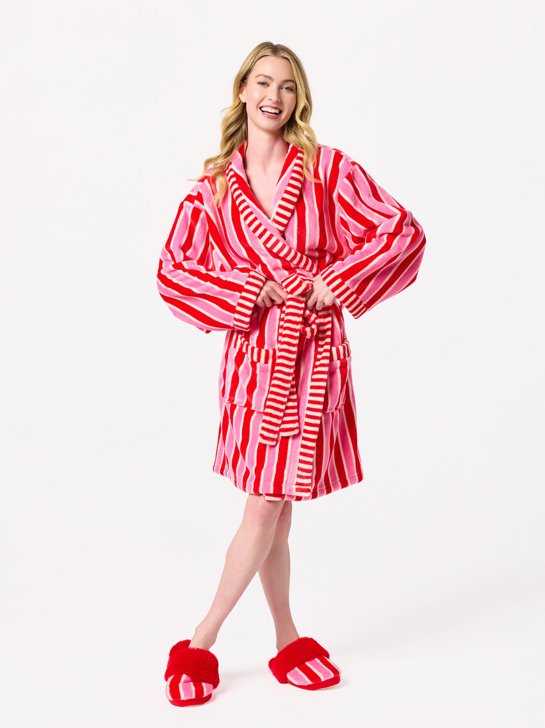 Woman in the pink and red stripe robe with hands on hips