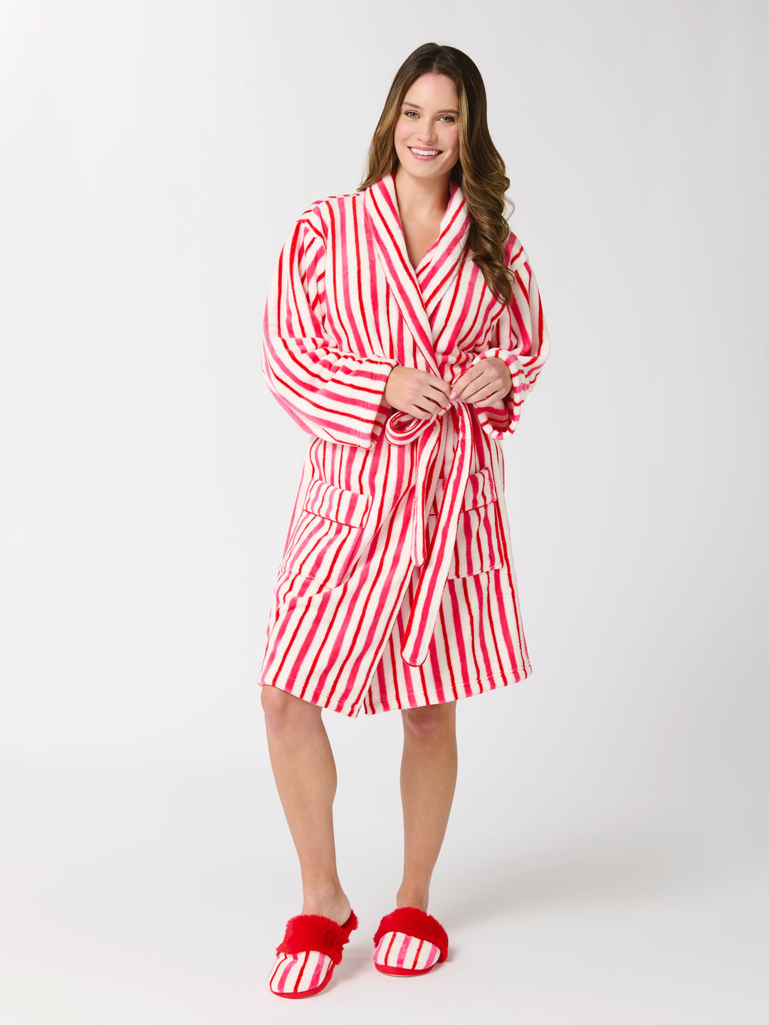 Woman in a red and white candy stripe robe and red faux fur slippers