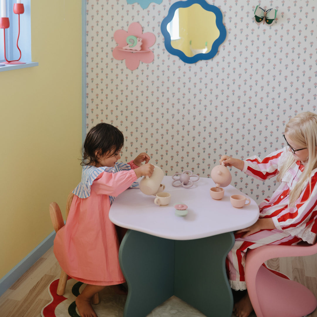 Child playing with the Mushie silicone tea set