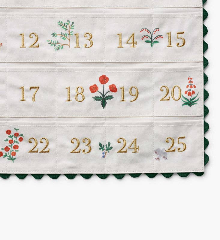 Close view of gold embroidered numbers 12 to 25 with florals on the nativity advent calendar pockets