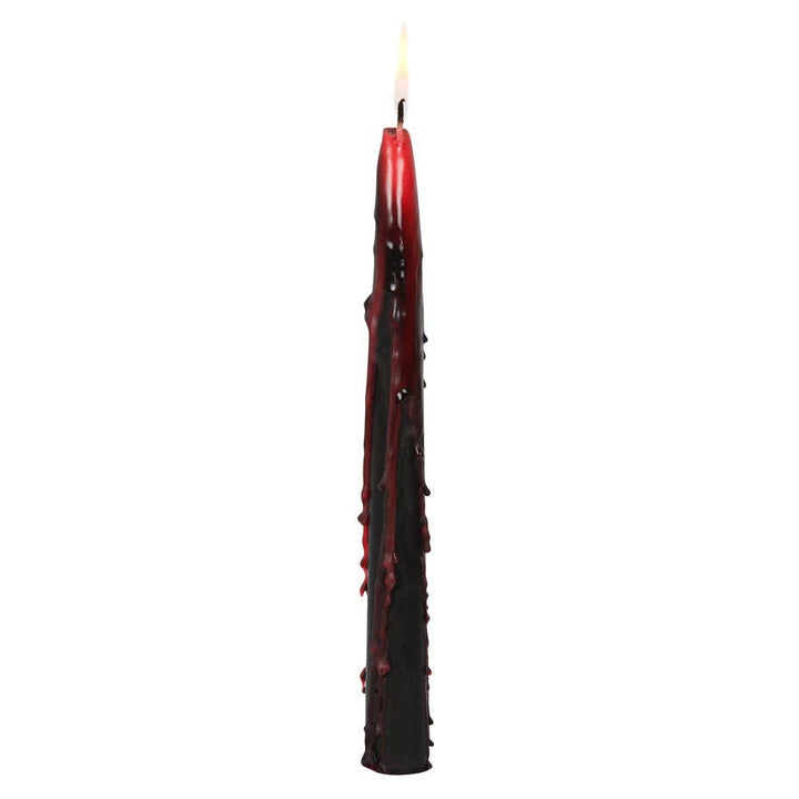 Single lit black taper with red wax drips running down its sides, eerie candlelight for Halloween night