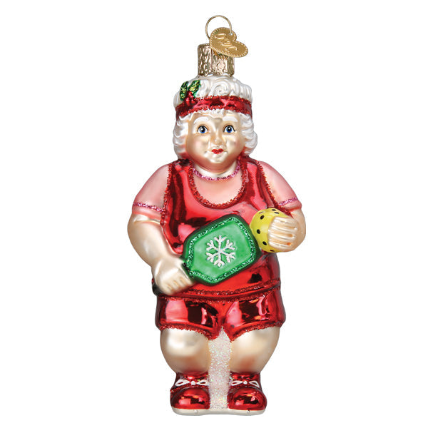 Front of the pickleball Mrs. Claus ornament holding a green paddle and yellow ball, on white