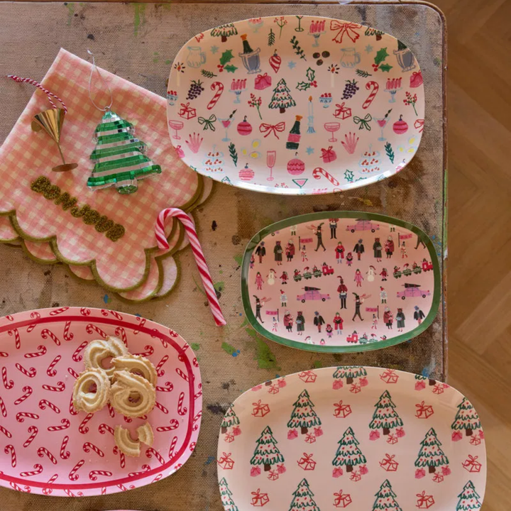 Candy cane plate of butter cookies with three other Rice Christmas plates, a candy cane, and a gingham napkin