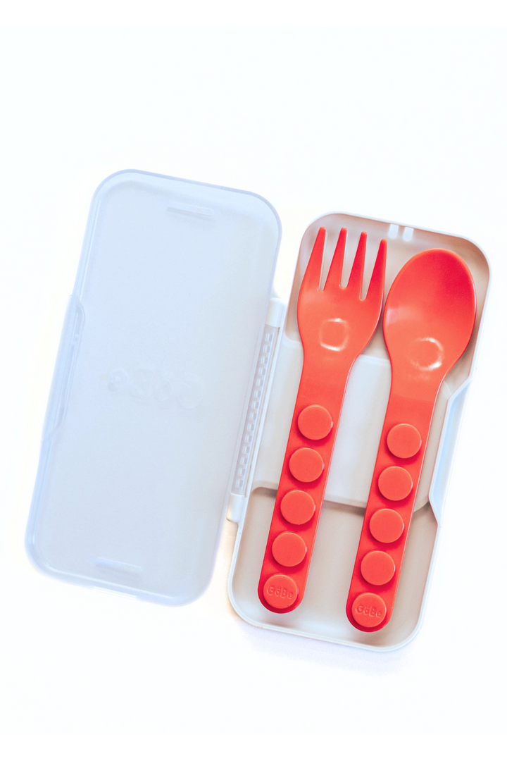 Red fork and spoon inside the closed snap-together travel case