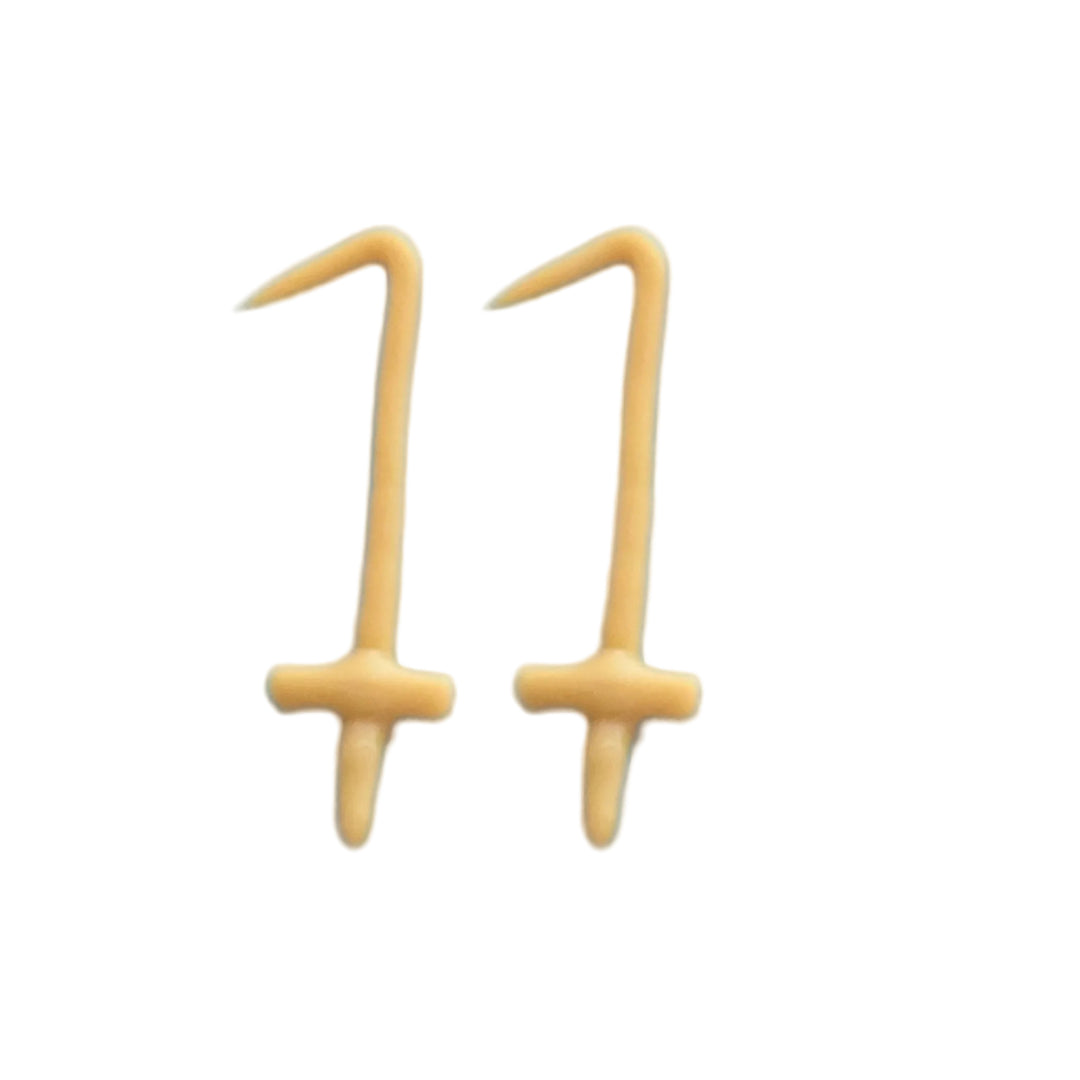 Two small gold-colored candles shaped like the number 1, arranged side by side on a white background