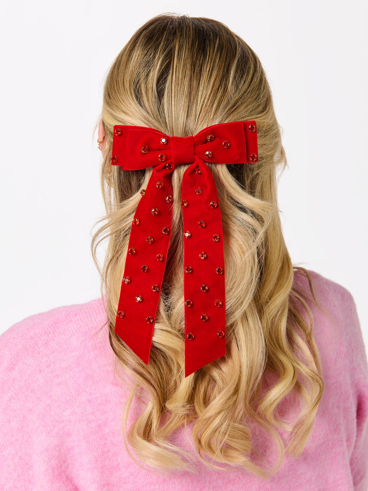 Red velvet rhinestone bow worn in long blonde hair