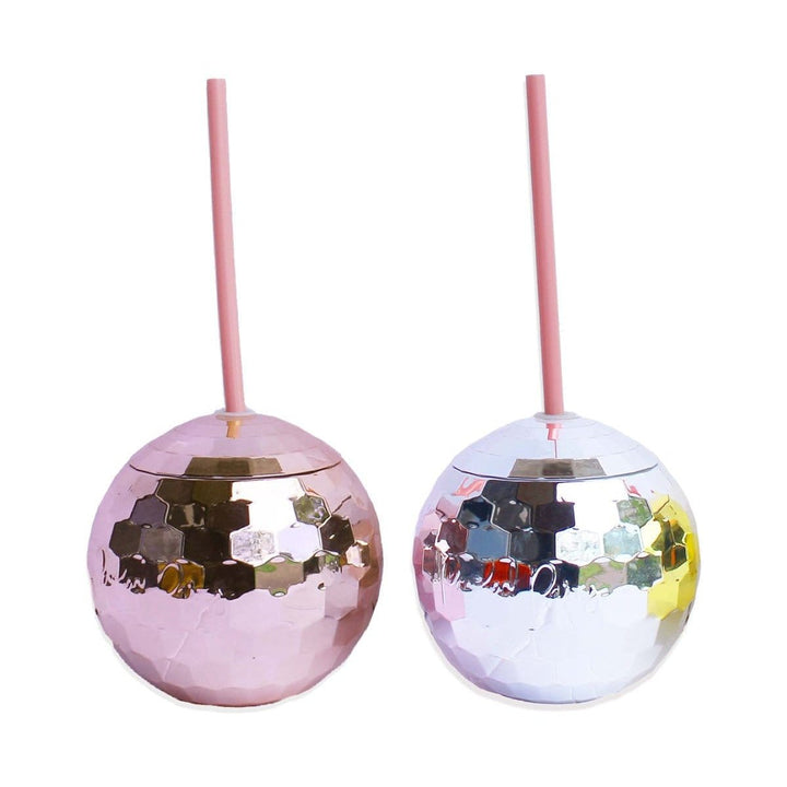 Pink and silver disco ball cups with pink straws side by side on a white background