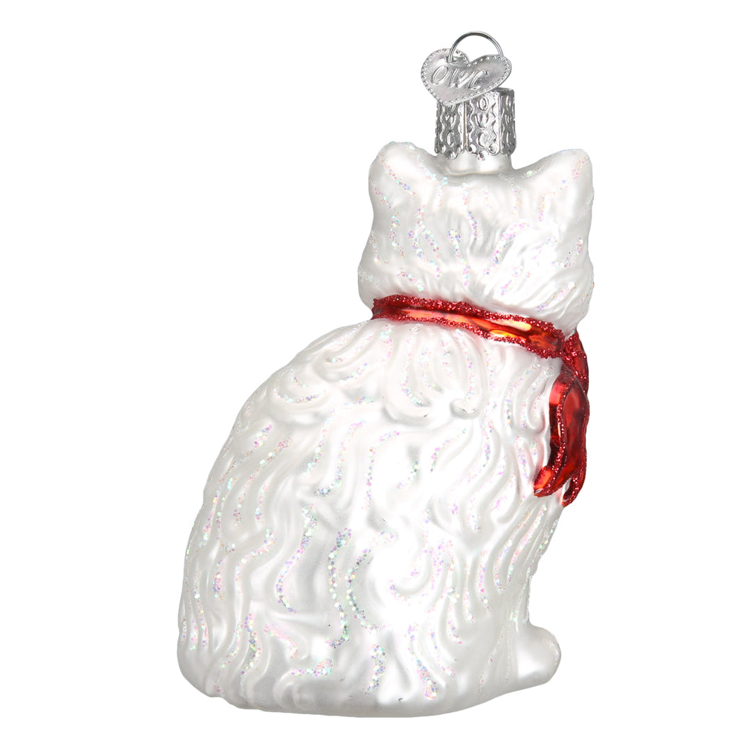 Back three-quarter view of the white cat ornament with glittered fur and the red bow at the neck