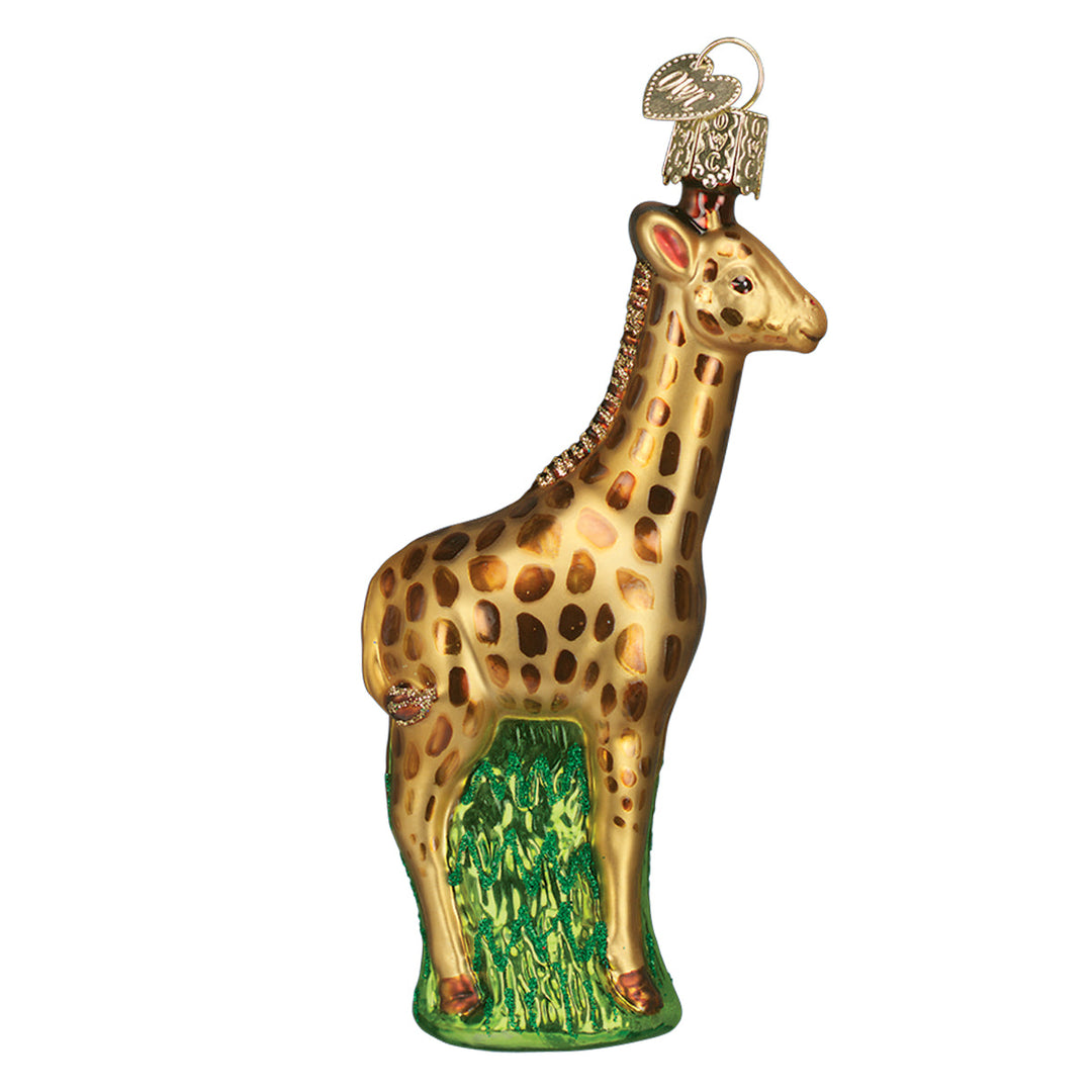 Right side of the baby giraffe ornament with brown spots and a green grass base, on white