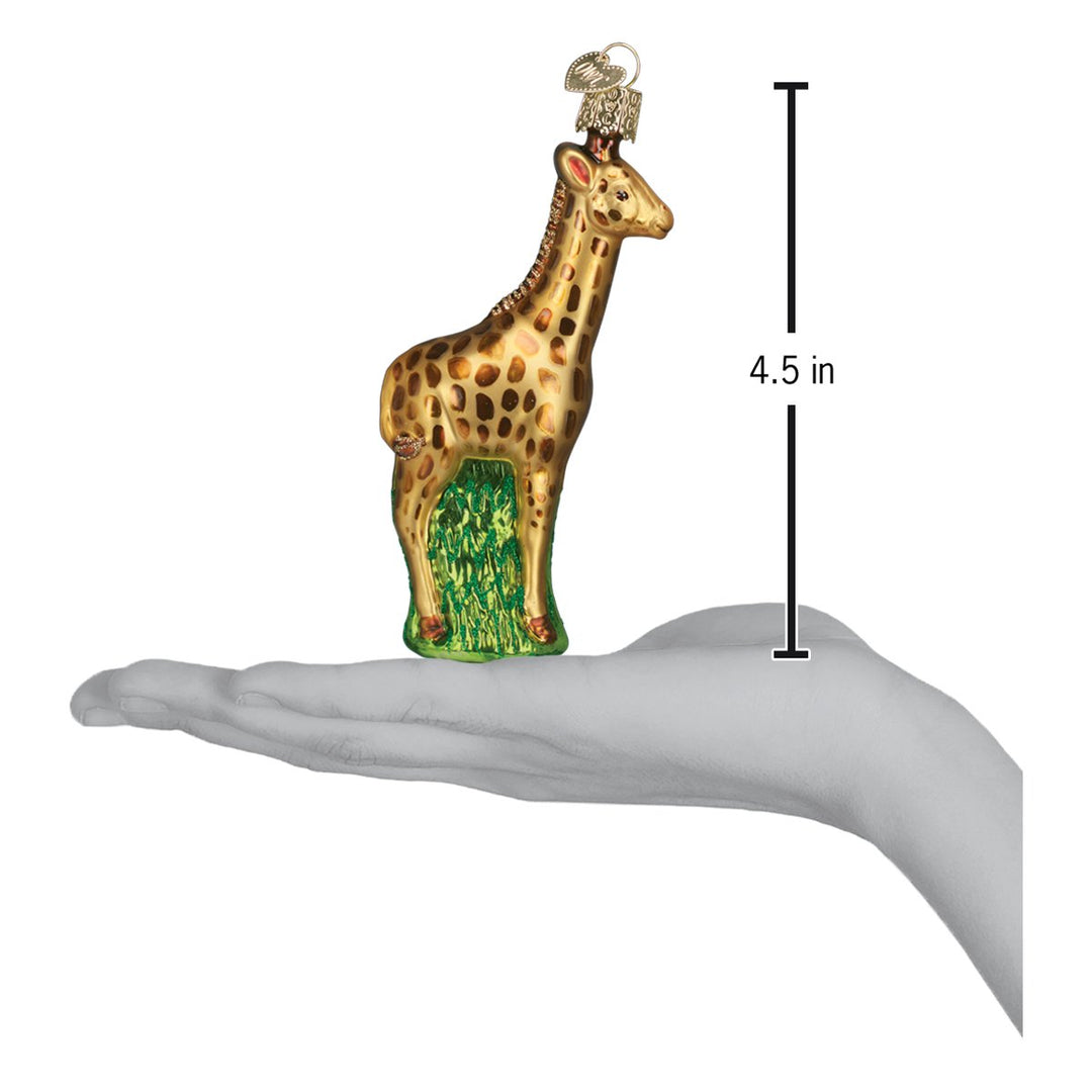 Baby giraffe ornament on an open palm beside a 4.5 inch height marker