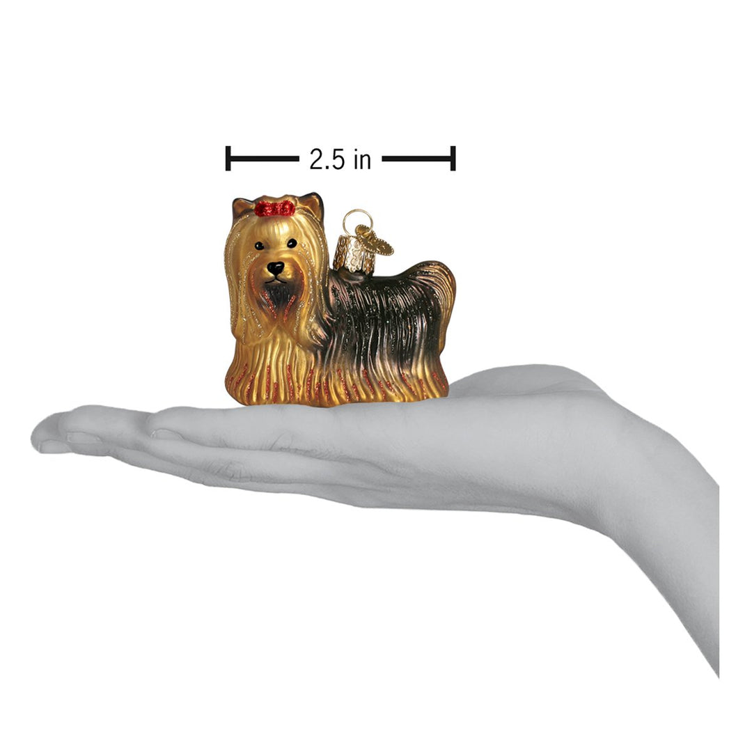 Yorkie ornament on an open palm with a 2.5 inch width marker for scale