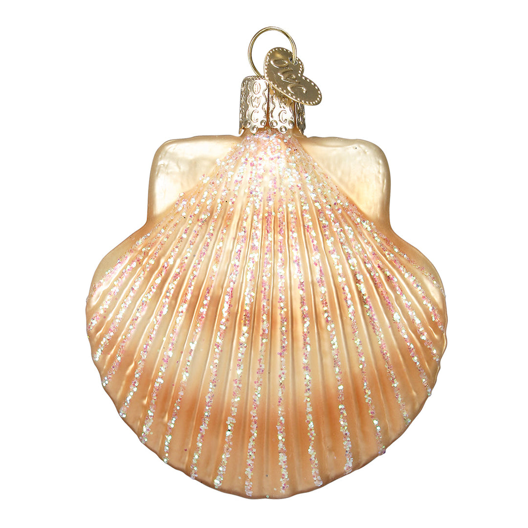 Front of the peach and ivory scallop shell glass ornament with glittered ridges, on white