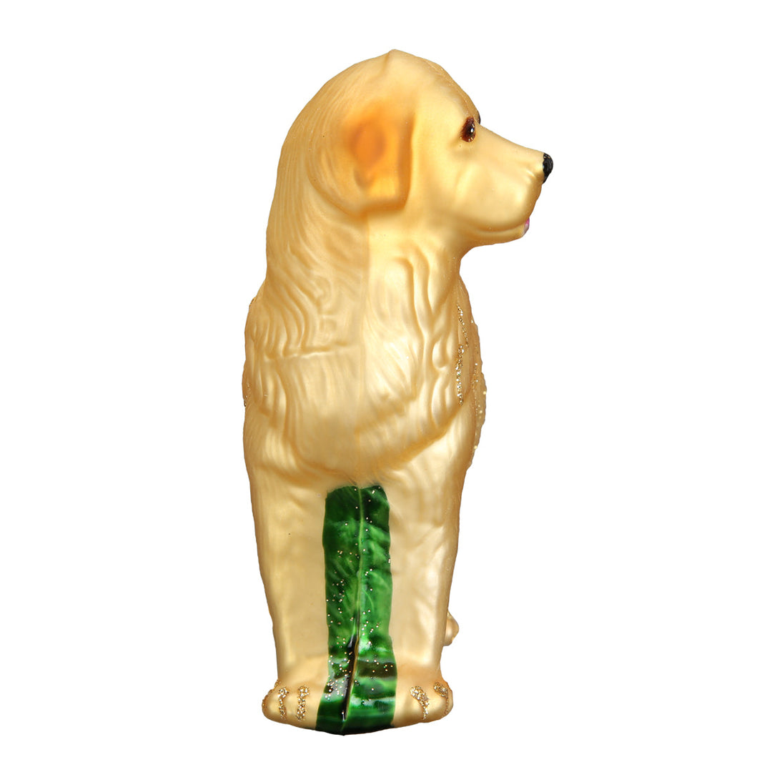 Golden retriever ornament seen end-on from the front, showing its slim profile and gold glitter coat