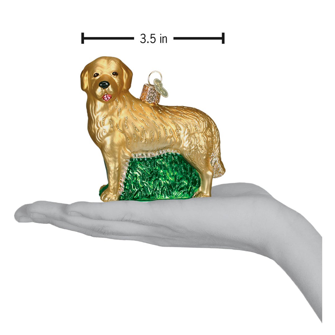Golden retriever ornament resting on an open palm with a 3.5 inch width marker for scale