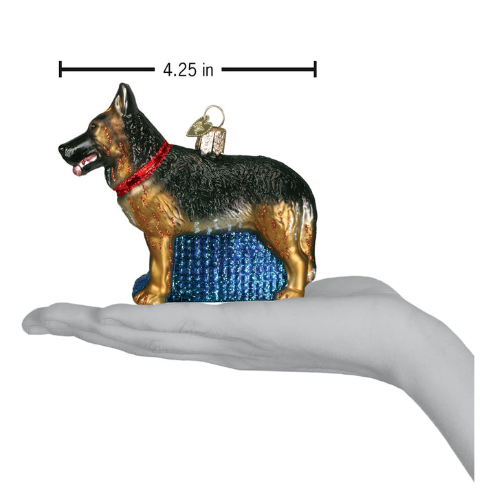 German Shepherd ornament on an open palm with a 4.25 inch width marker for scale