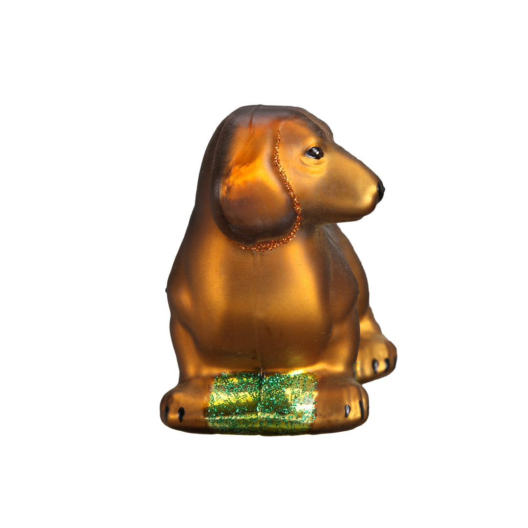 Dachshund ornament seen end-on from the front, showing its long ears and narrow profile