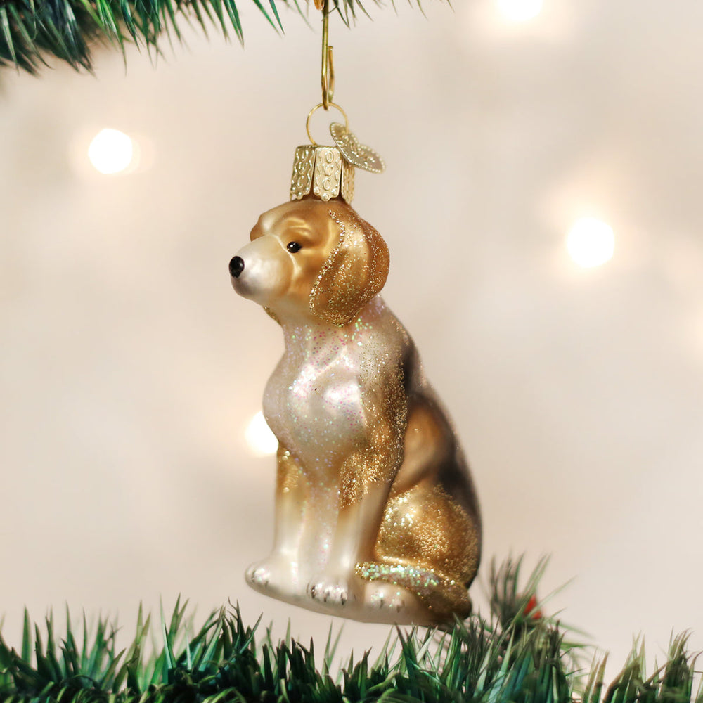 Beagle glass ornament hanging on a Christmas tree with soft twinkling lights