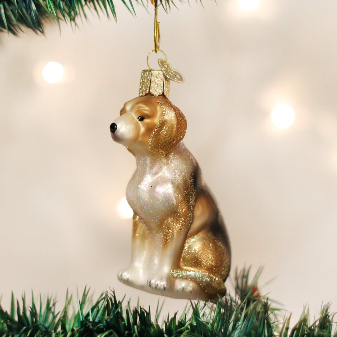 Beagle glass ornament hanging on a Christmas tree with soft twinkling lights