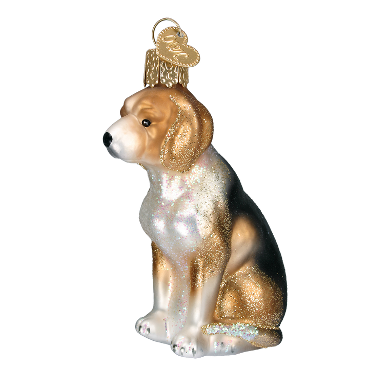 Tricolor beagle ornament sitting in tan, white, and black glass, three-quarter front view