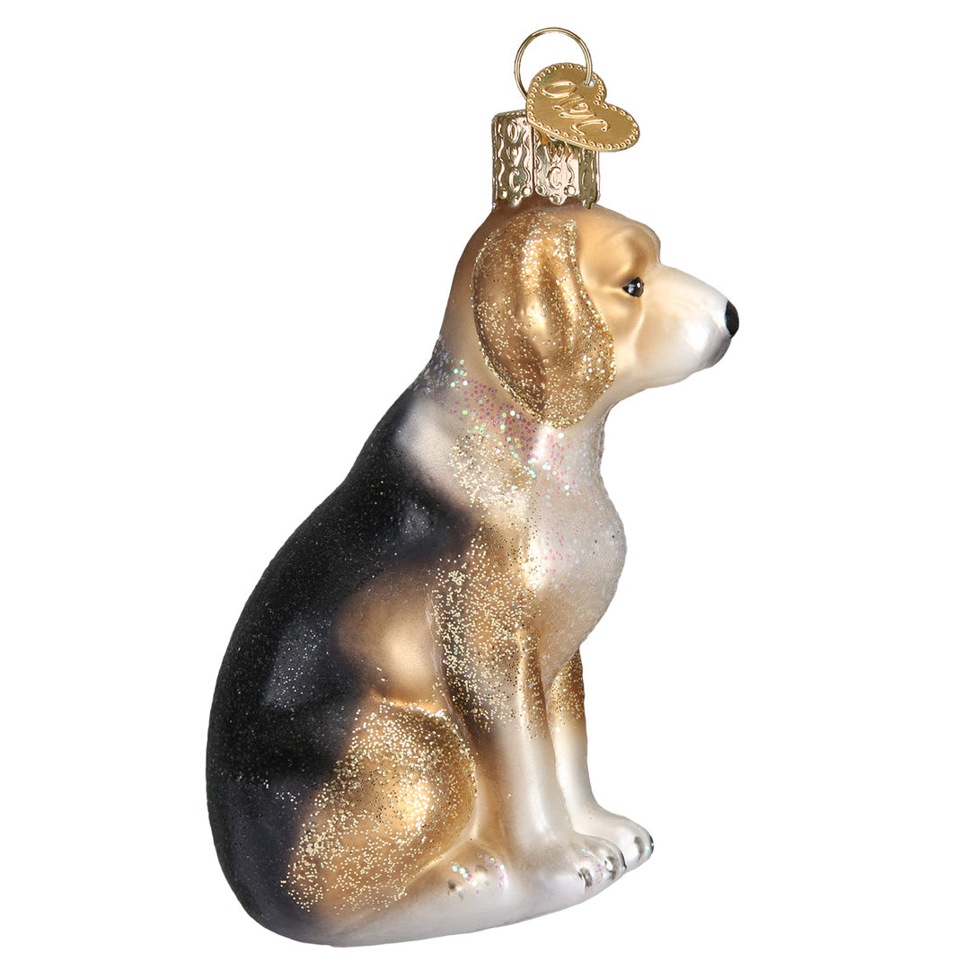 Side profile of the sitting beagle ornament showing its black saddle and tan ears