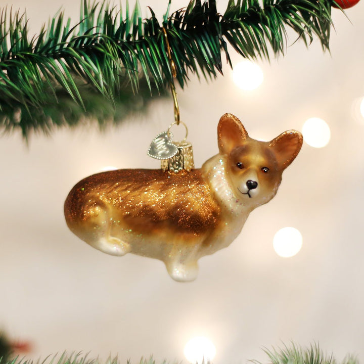 Corgi glass ornament hanging on a Christmas tree with warm twinkling lights