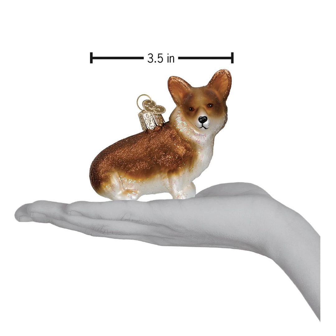 Corgi ornament on an open palm with a 3.5 inch width marker for scale